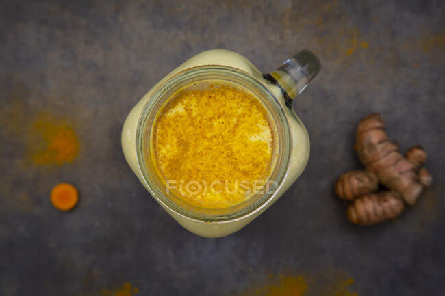 Jar of turmeric and lemon on a white background — Stock Photo