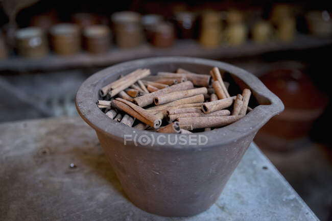 Cinnamon quills in an antique stonewear bowl — Stock Photo