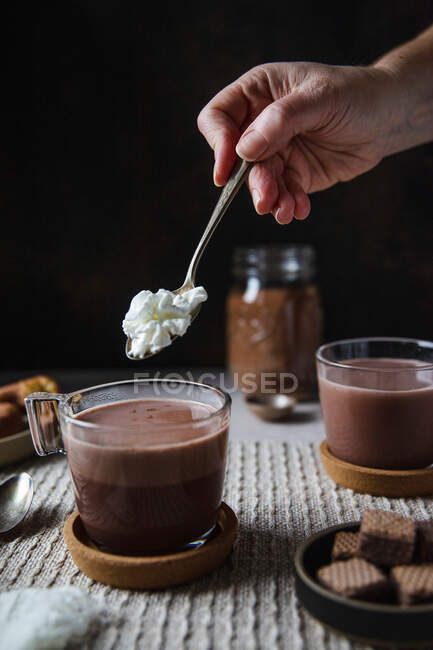 Chocolate with cream and nuts on a wooden table — Stock Photo