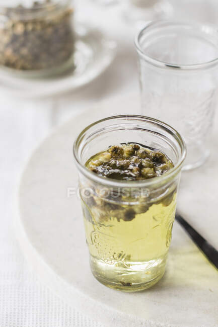 Chrysanthemum tea in glass on white — Stock Photo