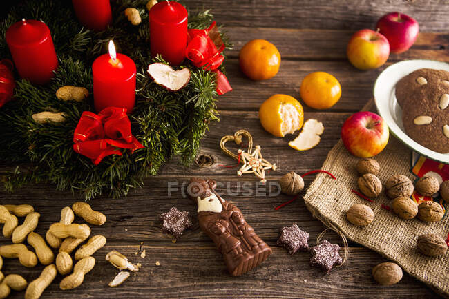 Рождественский венок, шоколадный Дед Мороз, орехи и пряники — стоковое фото