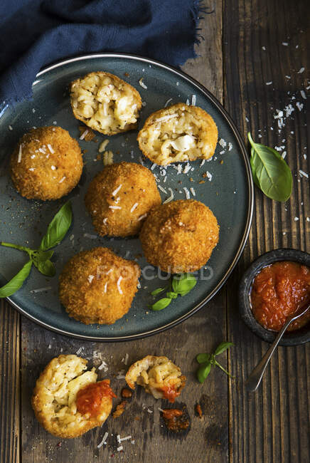 Arancini balls with mozzerella filling and tomato sauce — Stock Photo