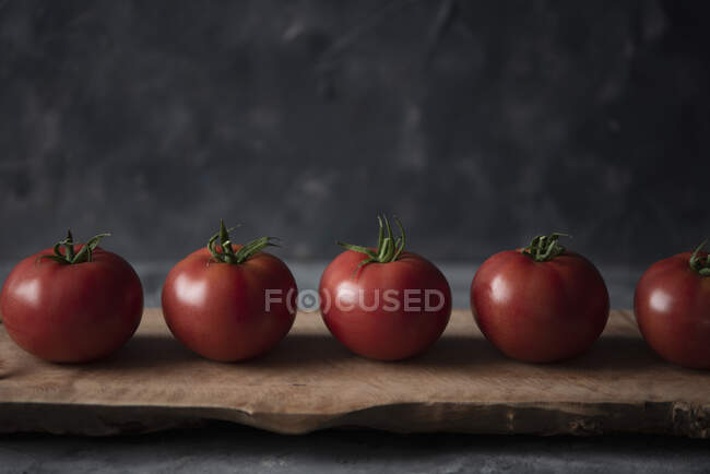 Tomatoes on a wooden board — Stock Photo