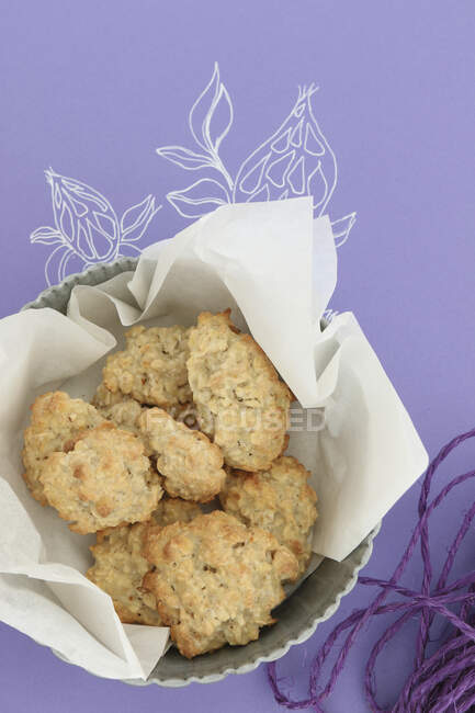 Gluten free oat biscuits in baking paper — Stock Photo
