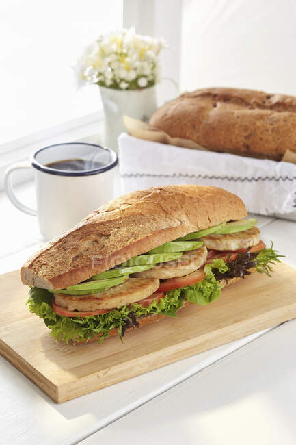 Chicken Avocado Sandwich with black coffee — Stock Photo