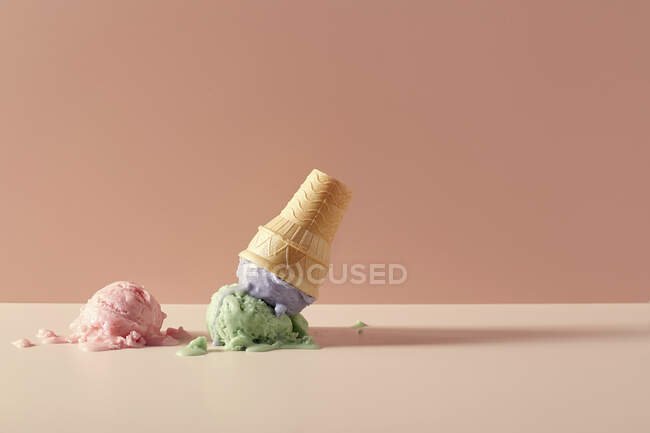 Ice Cream and Wafer Cup Cone melted on table — Stock Photo