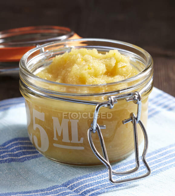 Apple and orange sauce with horseradish and vinegar in a flip-top jar — Stock Photo