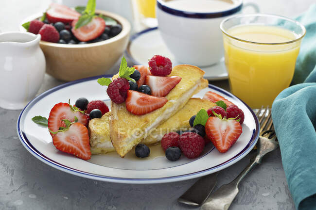 Baked french toast with cream cheese filling and fresh berries — Stock Photo