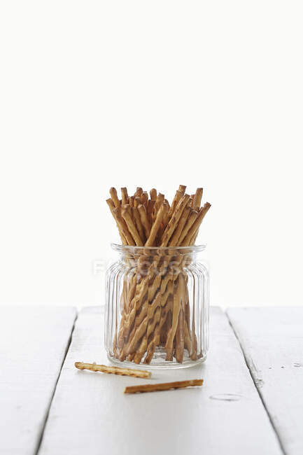 Salta Pinnar sticks in a glass jug — Stock Photo