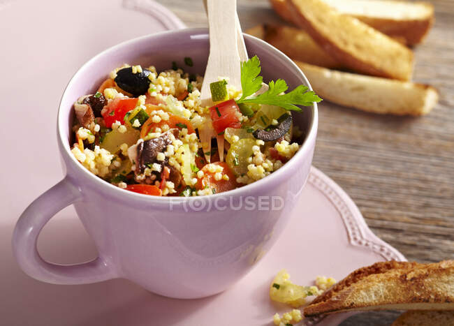 Vegan millet salad with vegetables and toasted bread — Stock Photo