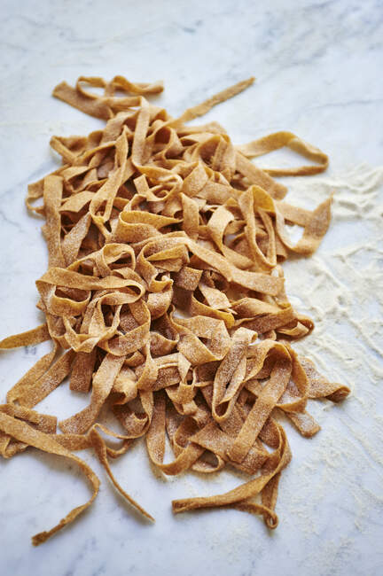 Homemade wholegrain pasta on white — Stock Photo