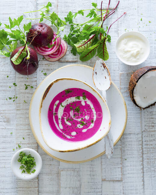 Beetroot and coconut soup with herbs — Stock Photo