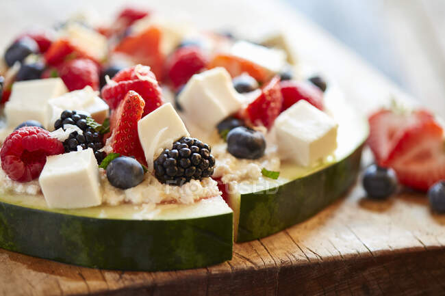 Berry salad with mozzarella cheese served on watermelon slices — Stock Photo
