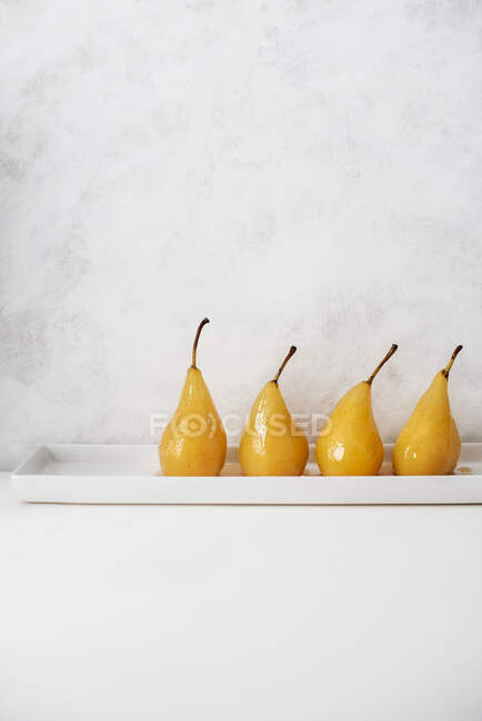 Poached pears, lined up — Stock Photo