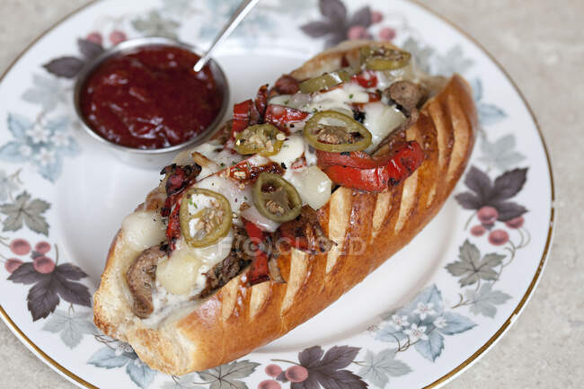Steak with cheese, jalapenos and peppers in a hot dog roll — Stock Photo