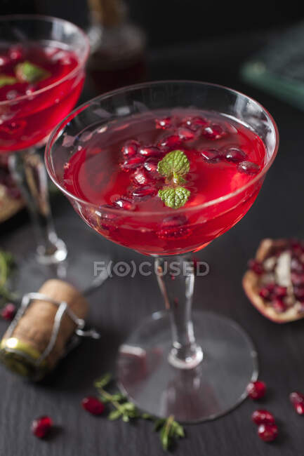 Pomegranate Champagne Cocktails in glasses with seeds and mint — Stock Photo