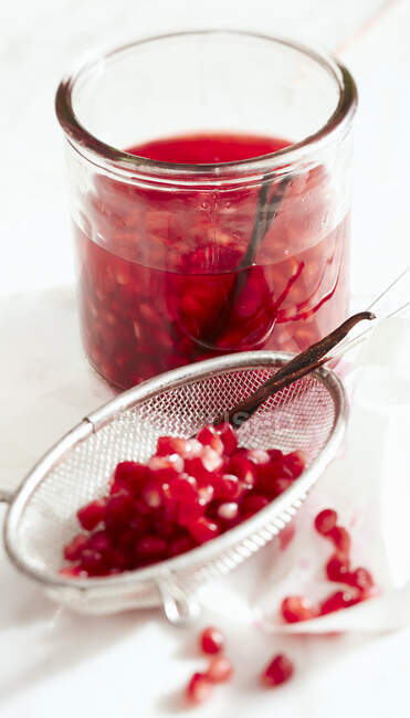 Homemade pomegranate essence in a jar with vanilla and balsamic vinegar Bianco — Stock Photo