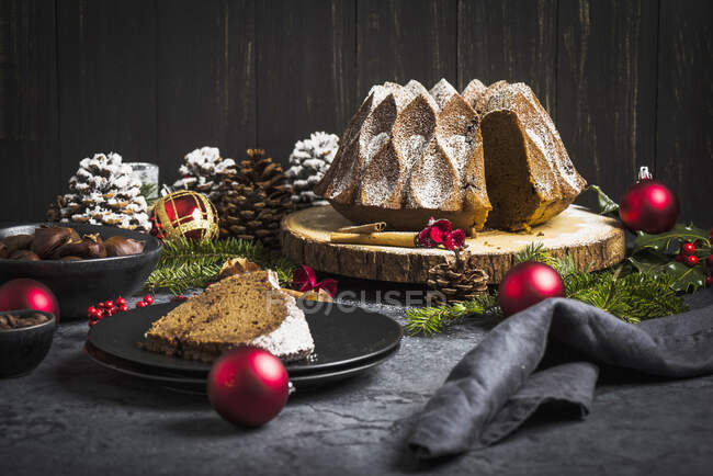 Christmas chestnut and chocolate cake on a tree bark disc — Stock Photo