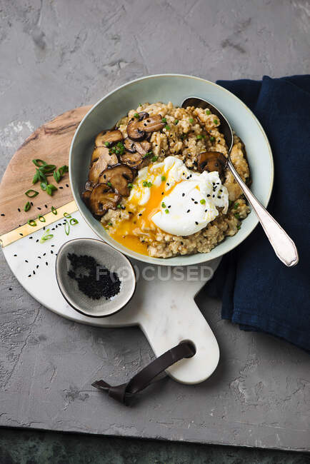 Oat porridge with fried mushrooms and egg — Stock Photo