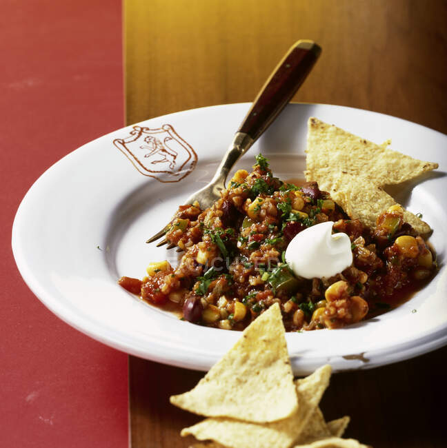 Vegetarian chili con carne made with green corn and tortilla chips — Stock Photo