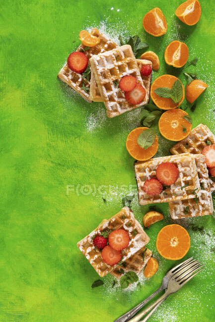 Waffles with strawberries and oranges — Stock Photo