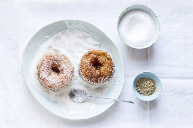 Apple donuts - apple rings wrapped in dough and and rolled in cinnamon sugar — Stock Photo
