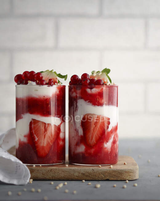 Strawberry yoghurts layered desserts in glasses — Stock Photo