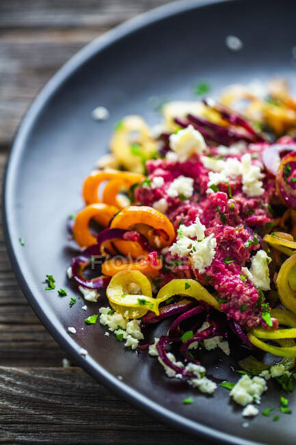 Vegetable noodles made from sweet potatoes with carrots, beetroot pesto and feta cheese — Stock Photo