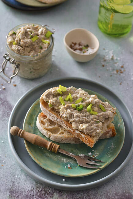 Fish paste with chives on bread slices — Stock Photo