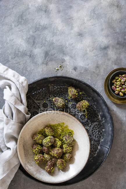 Easter eggs coated in dates, cocoa and pistachios — Stock Photo