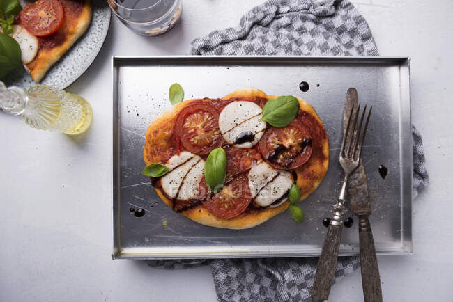 Pizza mit veganem Mozzarella, Tomaten, Basilikum und Balsamico-Essig — Stockfoto