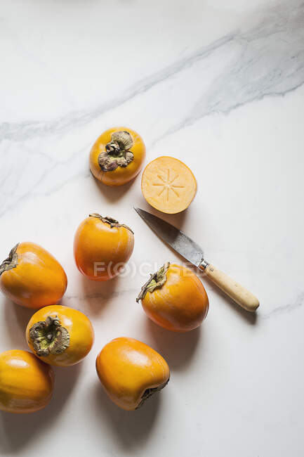 Nahaufnahme köstlicher Persimmons auf Marmor — Stockfoto