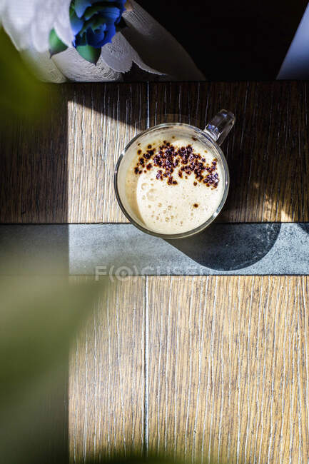 Espresso with cream and cocoa in glass cup — Stock Photo