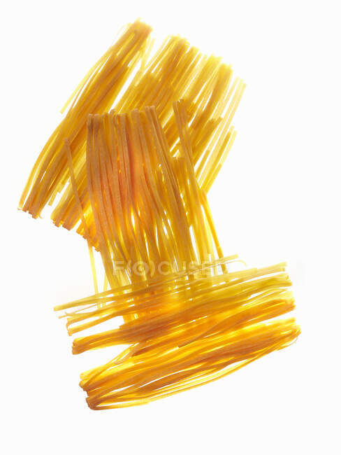 Ribbon pasta isolated on white — Stock Photo
