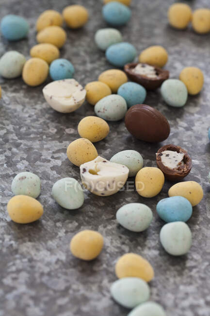 Various chocolate eggs on a textured surface — Stock Photo