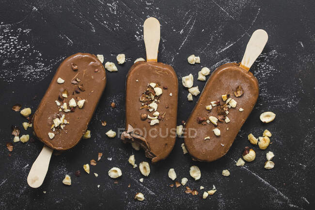Milk chocolate popsicles with hazelnuts — Stock Photo