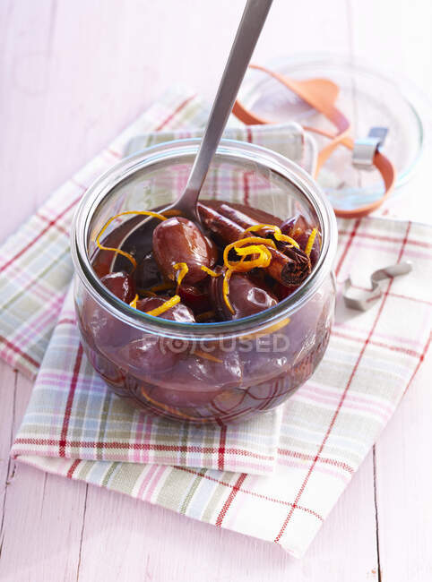 Homemade damson compote with orange zest in a preserving jar — Stock Photo