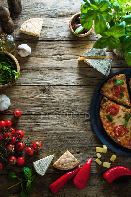 Italian pizza ingredients with cheese, tomatoes and basil — Stock Photo