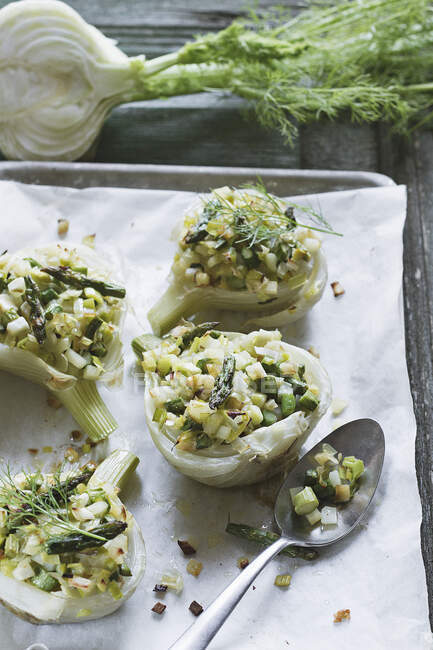 Fennel with a vegetable filling on a baking tray — Stock Photo