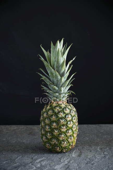 Pineapple on a slate plate — Stock Photo