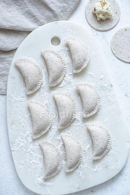 Gluten-fee uncooked dumplings ruskie served on marble board — Stock Photo