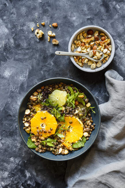 Lentil salad with citrus and nuts — Stock Photo
