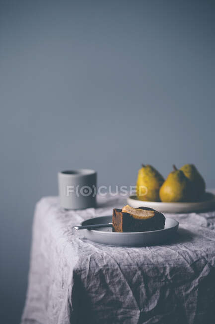 Plate with piece of a pear brownie, on a table — Stock Photo