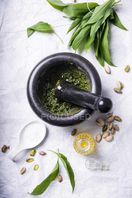 Vegan wild garlic pesto being made in a mortar — Stock Photo
