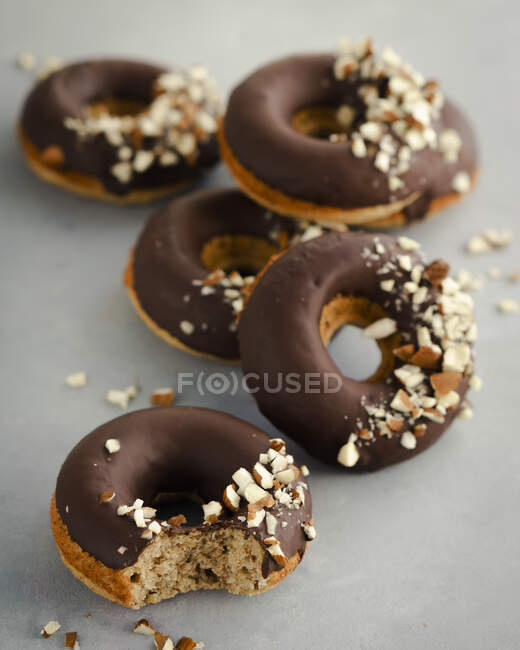 Hazelnut doughnuts with chocolate glaze and chopped hazelnuts — Stock Photo