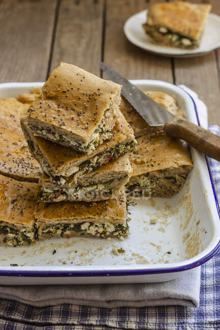 Borek cake with beetroot leaves and feta cheese, black sesame seeds — Stock Photo
