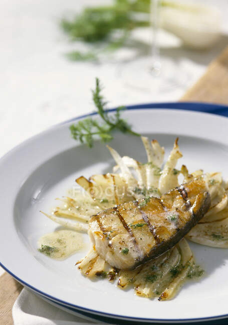 Grilled fish fillet on fennel slices — Stock Photo