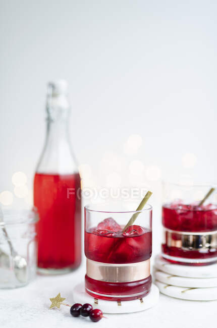 Cranberry Vodka in glasses and bottle on background — Stock Photo
