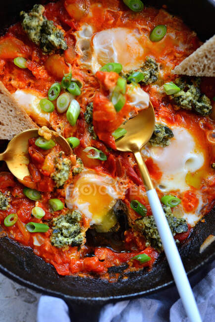 Shakshouka in a pan with bread — Stock Photo