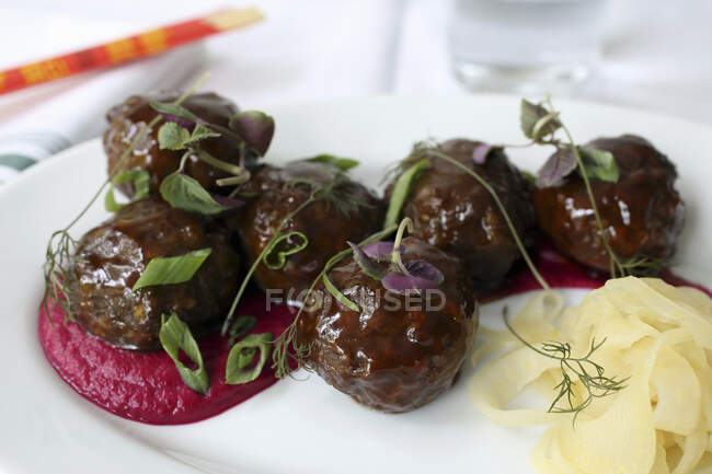 Meatballs with Berkshire pork, five spice-cider glaze, apple-beet-ginger pure and pickled fennel — Stock Photo